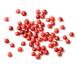 Wall Mural - dried pink peppercorns isolated on white, top view