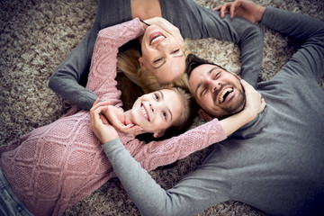 Sticker - Happy family are smiling to the camera,lying on the floor