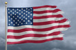 Flag of United States tattered and torn with stormy sky