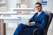 © Elnur - Young handsome businessman employee working in office at desk