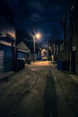 Shadow of a Person in a Dark City Alley at Night