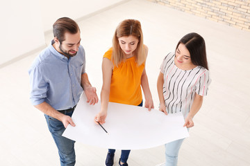 Poster - Real estate agent with trainee showing plan of apartment to client