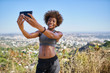 © Joshua Resnick - fit african american woman taking selfies at runyon canyon with los angeles in background