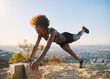 © Joshua Resnick - athletic young african american woman doing stretches and pushups at runyon canyon with view of los angeles in background