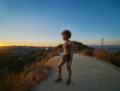 © Joshua Resnick - fit african american woman hiking runyon canyon stopping to see view of sunset