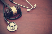 Wooden Gavel And Stethoscope On Wooden Background With Copyspace