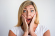 Shocked mature Caucasian woman with open mouth covering cheeks with hands. Client discovering losses caused by bad company service. Bad news or failure, concept