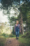 Fototapeta Nowy Jork - young woman walking in the forest