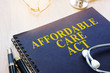 Affordable Care Act ACA and stethoscope on a table.