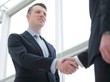 © ASDF - handshake of business partners after a favorable trade deal