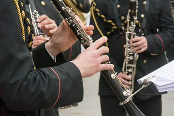 Wall Mural - Horizontal View of Close Up of Musicians Playing Clarinet in Black Uniform. Taranto, South of Italy