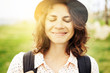 portrait of a beautiful young woman hipster girl in a hat blinking with pleasure, close-up, emotion, joy and happiness