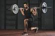 © LIGHTFIELD STUDIOS - Young sportsman doing exercise with barbell on shoulders in gym