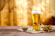 glass of beer with wheat on a wooden table background with copy space for text