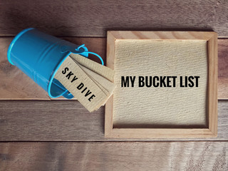 Inspirational and conceptual - ‘My bucket list ‘ written on a white framed paper. With vintage styled background.