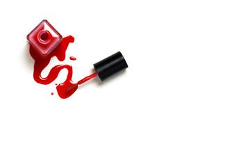 Spilled red nail polish on white isolated background. Cosmetic photography