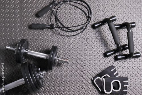 Accessories for fitness at home, mat, dumbbells of varying weights, jump rope, gloves for sports Poster Mural XXL