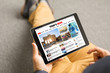 © Kaspars Grinvalds - Man reading news website on tablet. All contents are made up.