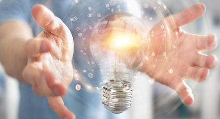 Poster - Businessman connecting modern lightbulbs with connections 3D rendering