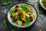 Fototapeta  - Fresh Beet, Orange salad with wild rocket, cheese and Pine nuts. healthy summer food