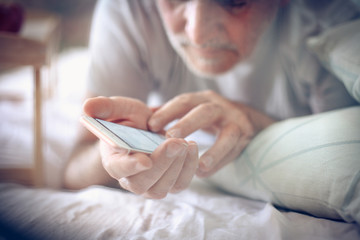 Wall Mural - Mobile phone in bed.