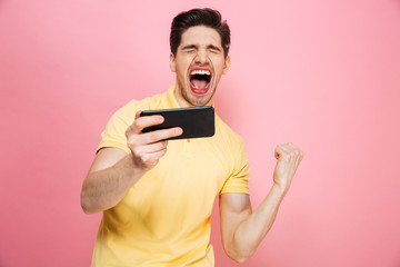 Poster - Portrait of a cheerful young man playing games