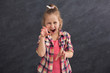 © Prostock-studio - Funny little girl imitating cat on dark background