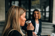 © bnenin - Side view image of laughing young businesswoman drinking coffee. Making a face.