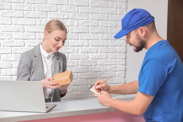 Poster - Female receptionist receiving parcel at workplace