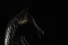 Head Of A Black Chess Knight Closeup On A Dark Background