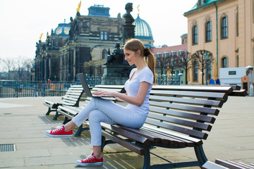 The girl in The Dresden sitting on the bench and writes in diary and laptop