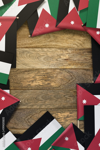 Fotografie, Obraz Jordan small flags framing a wood texture background with copy space