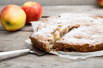 Wall Mural - apple pie with whole-grain flour on a wooden background. concept of healthy eating