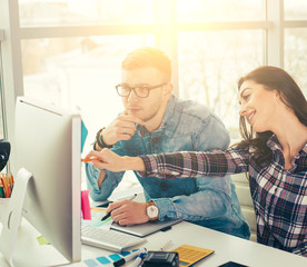 Cute creative designers working on new project in modern office