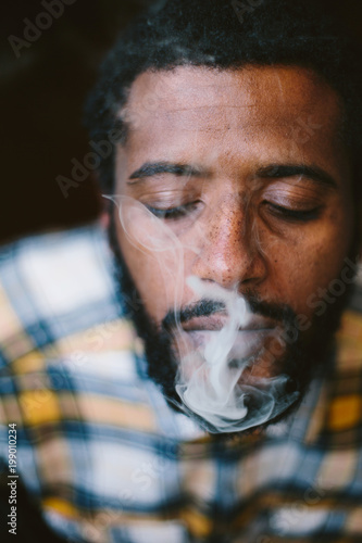 Portrait Of Guy Smoking Cigarette Mixed Race Man With African