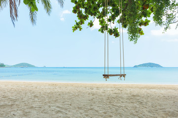 Wall Mural - Tropical beach and swing under trees