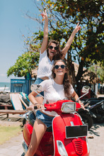 Two Lovely Woman With Happy Smiles Out For A Motorbike Ride At The Seaside. Stylish Casual Outfit. They Are Laughing With Raised Up Hands. True Happy Emotions, Active Lifestyle, Trip, Travel