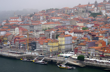 View of the embankment of the Douro River in Porto during the fog, Portugal.