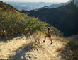 © Joshua Resnick - fit african american woman running at runyon canyon with los angeles in background