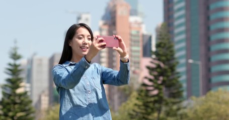 Sticker - Woman taking photo with cellphone in city