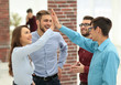 © ASDF - happy creative business people giving high-five in meeting room.