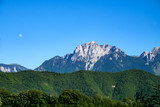 Fototapeta Góry - high craggy mountains with rising moon and blue sky in Bosnia and Herzegovina