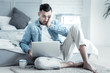 © Viacheslav Yakobchuk - So much work. Nice pleasant handsome man sitting in front of the laptop and holding his cheek while feeling confused