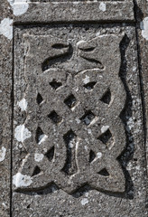 Wall Mural - stone carved Celtic dragons design on old gravestone