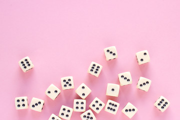 Gaming dice with copy space on pink background. Concept for games, game board, presentation, banners or web. Top view. Close-up.