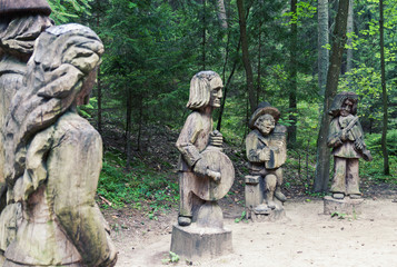 Traditional Lithuanian wood carving art sculptures of folk musicians in public nature park in Juodkrante