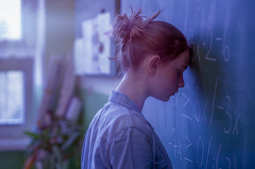 Wall Mural - Teenager girl in math class overwhelmed by the math formula. Pressure, Education, Success concept.