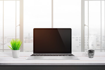 Leinwandbilder - Modern laptop on white wooden desk for mockup, web site design promotion. Plant and cup of coffee beside. Window and sun light in background.