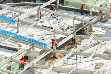 Wall Mural - Construction site with workers on the building roof