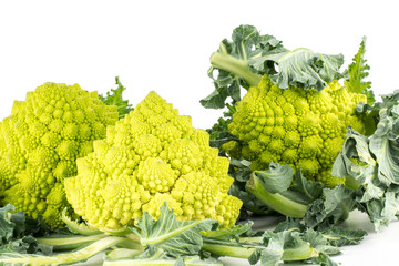 Romanesco cauliflower or broccoli isolated on white background three green heads with leaves.